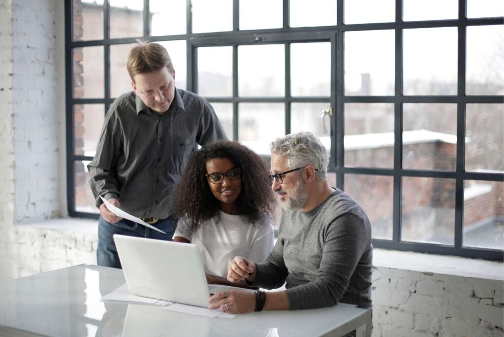 Senior couple sitting with financial advisor planning their retirement
